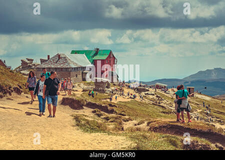 Bucegi Mountains, Romania - August 6, 2016: Tourists hike the trails to the Babele (The Old Women) chalet at 2206 m altitude in Bucegi Mountains. Stock Photo