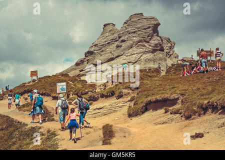 Bucegi Mountains, Romania - August 6, 2016: Hundreds of people hike the trails to the Sphinx, the mythical megalith with  human face resemblance. Stock Photo