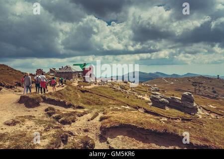 Bucegi Mountains, Romania - August 6, 2016: Tourists hike the trails to the Babele (The Old Women) chalet at 2206 m altitude. Stock Photo
