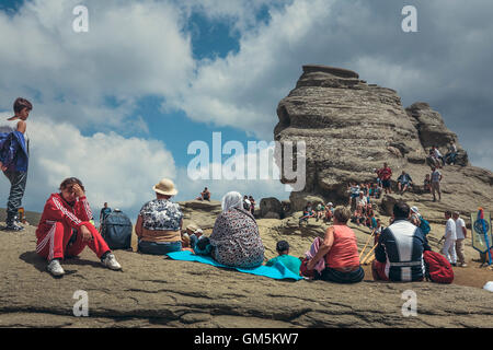 Bucegi Mountains, Romania - August 6, 2016: People come to contemplate, meditate or rest at Sphinx, the famous megalith with human face likeness. Stock Photo