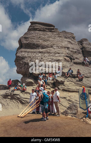 Bucegi Mountains, Romania - August 6, 2016: People come to contemplate, meditate or rest at Sphinx, the famous megalith with human face likeness. Stock Photo