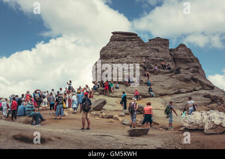 Bucegi Mountains, Romania - August 6, 2016: Tourists come to contemplate, meditate or rest at Sphinx, the legendary megalith Stock Photo