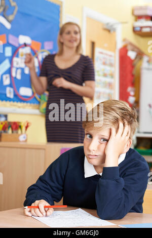 Male Elementary School Pupil Struggling In Class Stock Photo - Alamy
