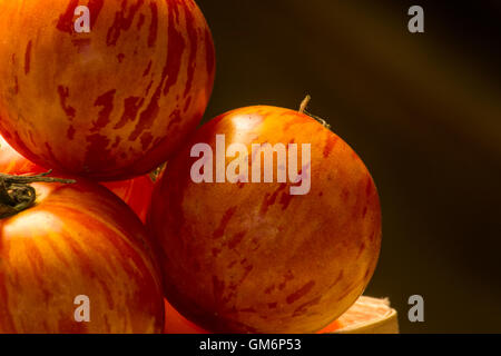 three small red zebra tomatoes Stock Photo