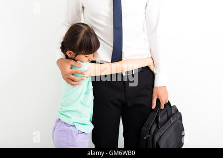 father comforting his crying daughter before go to work Stock Photo