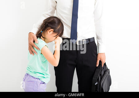 father comforting his crying daughter before go to work Stock Photo
