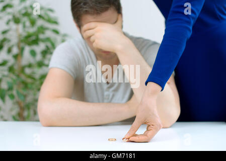 Divorce concept. Woman returning wedding ring to her husband. Stock Photo