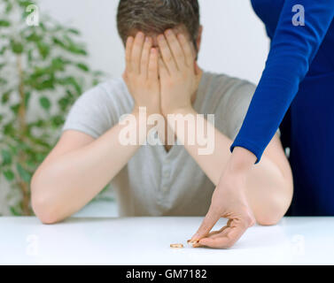 Divorce concept. Woman returning wedding ring to her husband. Stock Photo