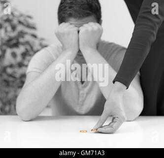 Divorce concept. Woman returning wedding ring to her husband. Stock Photo