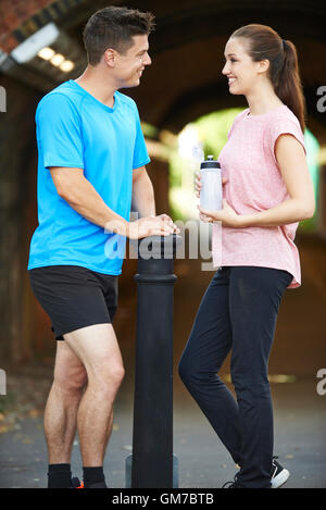 Young Couple Exercising In Urban Environment Stock Photo