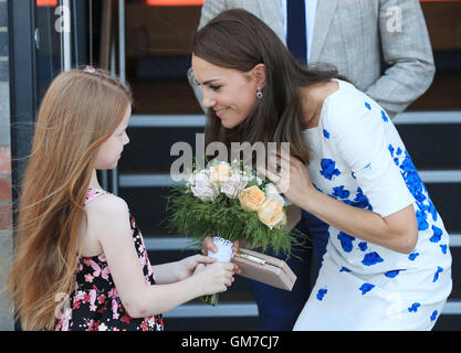 The Duchess of Cambridge is presented with a posy of flowers as she leaves Bute Mills in Luton, following a tour of the facilities of national charity Youthscape with the Duke of Cambridge. Stock Photo