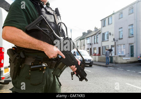 PSNI officers and Army technical officers search properties on Old Glenarm Road in Larne, Co Antrim. A Royal Marine is being questioned by detectives investigating Northern Ireland-linked terrorism, understood to be connected to two major dissident republican arms finds. Stock Photo