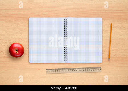 School notebook, apple, pencil and ruler on desk top view Stock Photo