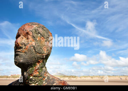 Modern art statues forming the Another Place by Antony Gormley on Crosby Beach on April 4, 2013. Stock Photo