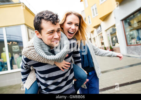 Young couple in love in town having fun, laughing Stock Photo