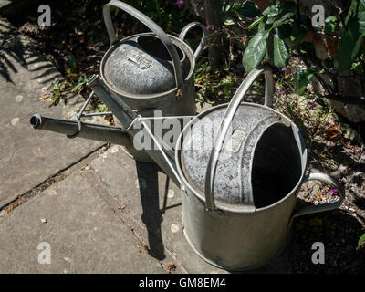 Two old watering cans Stock Photo