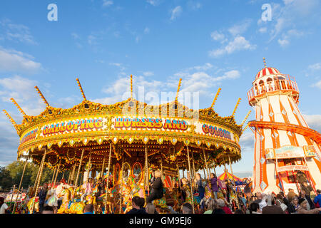 Traditional funfair rides. A merry go round and helter skelter at Goose Fair, Nottingham, England, UK Stock Photo