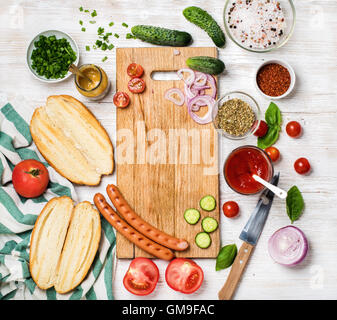 Ingredients for making hot-dogs over white painted wooden background Stock Photo