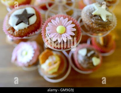 Decorated cupcakes on a display stand. Stock Photo