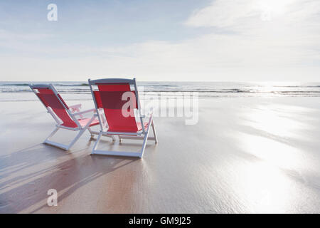 Maine, Red deckchairs on empty beach Stock Photo