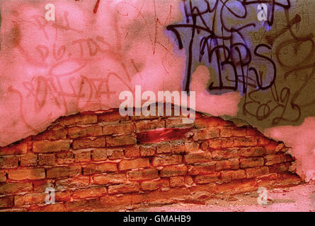 Graffiti Covered Broken Stucco Facade Exposes Brick Wall Beneath It Stock Photo