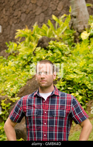Portrait of a man looking out wearing a plaid shirt. Stock Photo