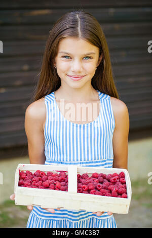 Beautiful brunette little girl holding gifts clueless and confused ...