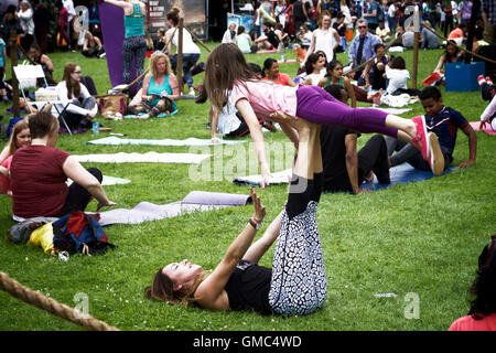 Yoga pose: mother child at the International Yoga Day at Alexandra Palace, north London, UK. Stock Photo