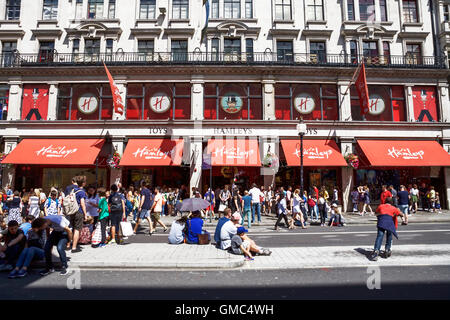Hamleys toy shop, Regent Street London, UK.  A traffic free day allows shoppers to walk or sit in the road. Stock Photo