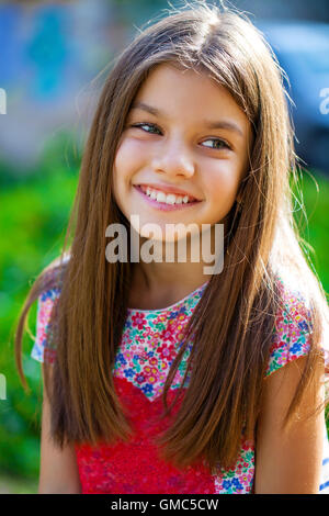 Close up portrait of a beautiful nine year old little girl in autumn park Stock Photo