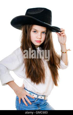 Portrait of a beautiful little girl in a black cowboy hat, studio on white isolated background Stock Photo