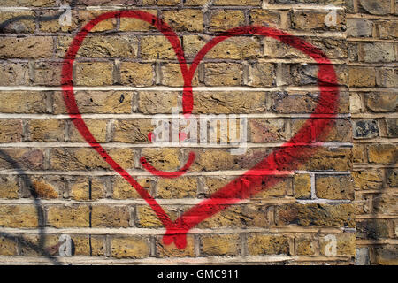 Hackney. Love heart graffiti with smiling face. Stock Photo