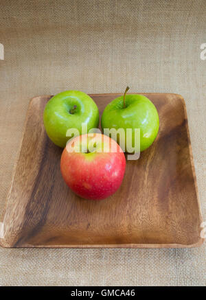 Two green and one red apples Stock Photo