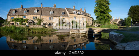 The river Eye flows through the Cotswold village of Lower Slaughter  an ancient hamlet just West of Bourton on the Water Stock Photo