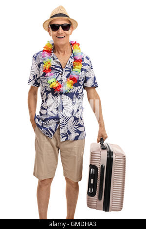 Senior tourist holding a suitcase isolated on white background Stock Photo