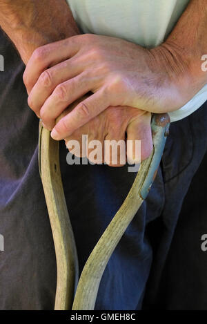 mature male gardener resting hands on top of fork Stock Photo