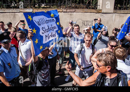 Prague, Czech Republic. 25th Aug, 2016. Demonstrators protest as Angela Merkel visits Prague. © David Tesinsky/Svobodne Forum/ZUMA Wire/Alamy Live News Stock Photo
