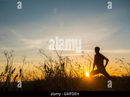 Billingham, north east England, UK. 27th Aug, 2016. Weather: A jogger stretching at sunrise in Cowpen Woodland park near Billingham on a glorious Saturday morning in north east England. Credit:  Alan Dawson News/Alamy Live News Stock Photo