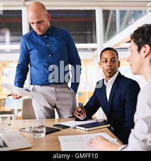 Three well dressed, dynamic programmers working together on assignment Stock Photo
