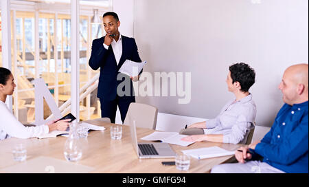 Businessman giving presentation to 3 board member in conference room Stock Photo