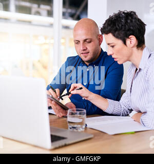 business man and woman working on their computer together Stock Photo