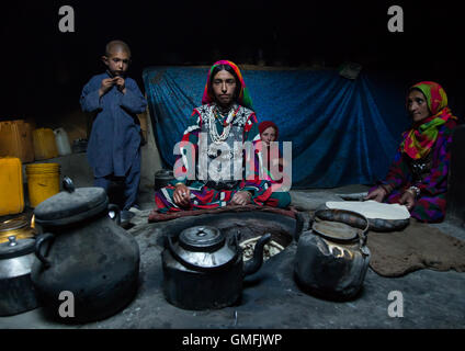Afghan woman making bread inside her traditional pamiri house, Badakhshan province, Khandood, Afghanistan Stock Photo