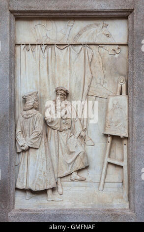 Leonardo da Vinci presents the real size model of the equestrian monument to Duke Francesco Sforza in his studio in Milan to Duke Ludovico Sforza of Milan. Marble relief on the pedestal of the Monument to Leonardo da Vinci by Italian sculptor Pietro Magni colmpeted in 1872 in Piazza della Scala in Milan, Lombardy, Italy. Stock Photo