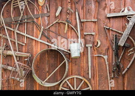 Rustic background, collection of old vintage farming tools on wooden wall Stock Photo