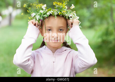 Portrait of a girl with a wreath of flowers on her head Stock Photo