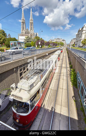 Vienna, Austria - August 14, 2016: Tram entering tunnel with Votive Church in distance. Stock Photo