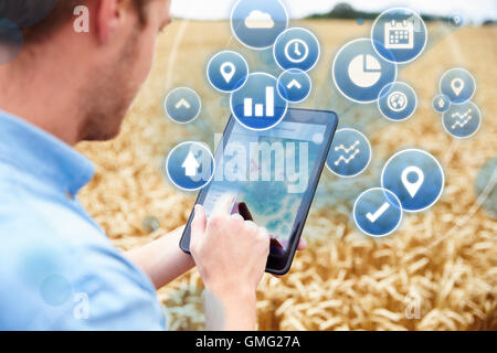 Composite Of Farmer In Field Accessing Data On Digital Tablet Stock Photo