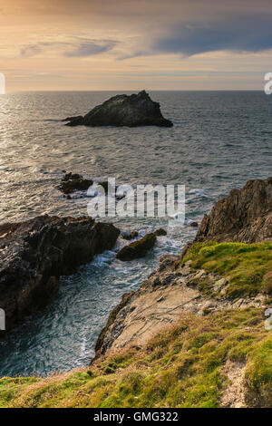 The Goose, a small rocky island off the coast of East Pentire Headland in Newquay, Cornwall. Stock Photo
