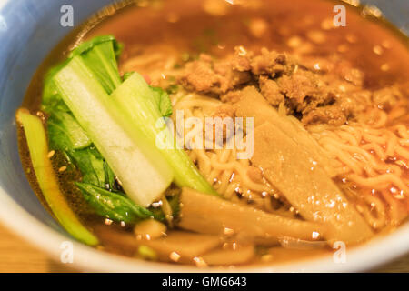 close up of bowl of japanese ramen with pickles on the side Stock Photo