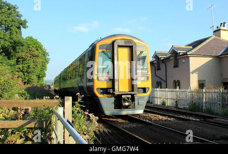 A passenger train run by “Northern” passes Cobweb Cottage near Skipton Stock Photo